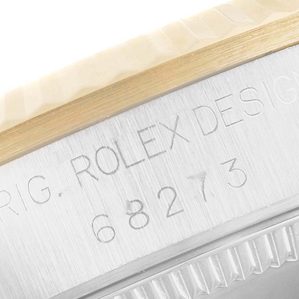 This close-up angle shows the engraved model number and part of the bezel of the Mid-Size Rolex watch.