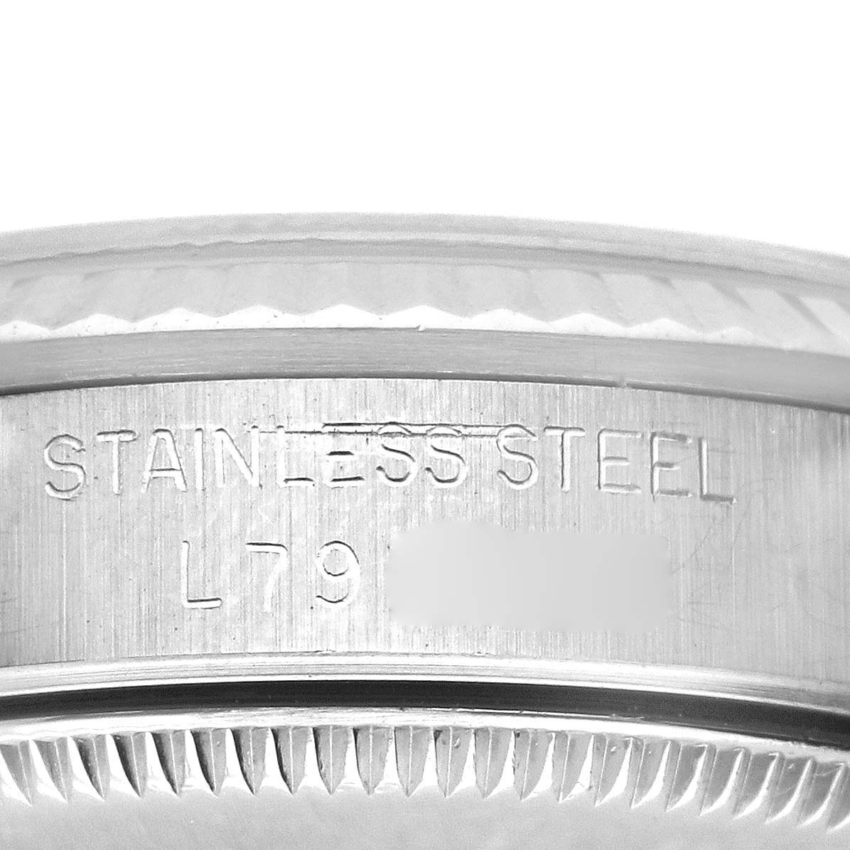 The image shows a close-up of the side of the Rolex Mid-Size 68274 Women's Stainless Steel Silver Dial 68274 Women's Stainless Steel Silver Dial watch, highlighting the engraved "STAINLESS STEEL" text.