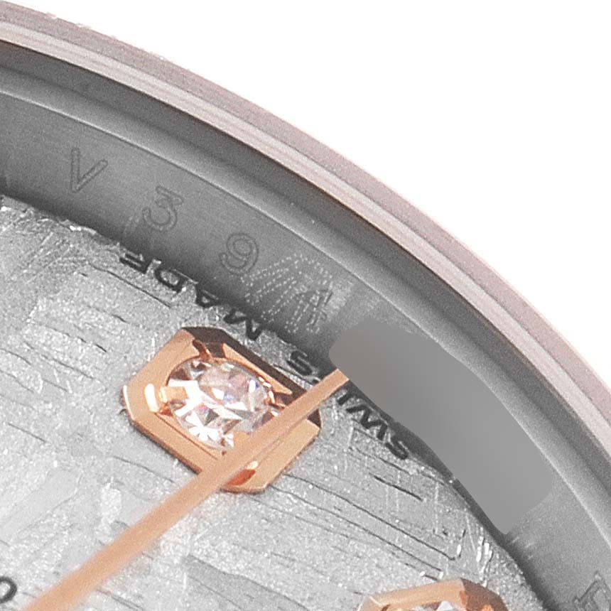 This close-up image of the Rolex Datejust 179171 Women
s Steel and Gold (two tone) Silver Dial 179171 Women
s Steel and Gold (two tone) Silver Dial watch shows part of the dial, including diamond hour markers and the inner bezel with the serial number.