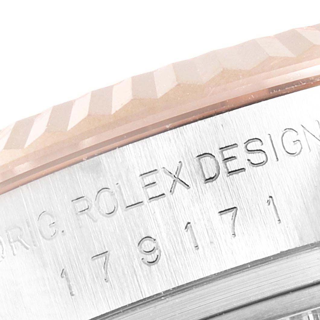 This close-up image shows the fluted bezel and part of the engraved case of a Rolex Datejust 179171 Women
s Steel and Gold (two tone) Silver Dial 179171 Women
s Steel and Gold (two tone) Silver Dial watch.