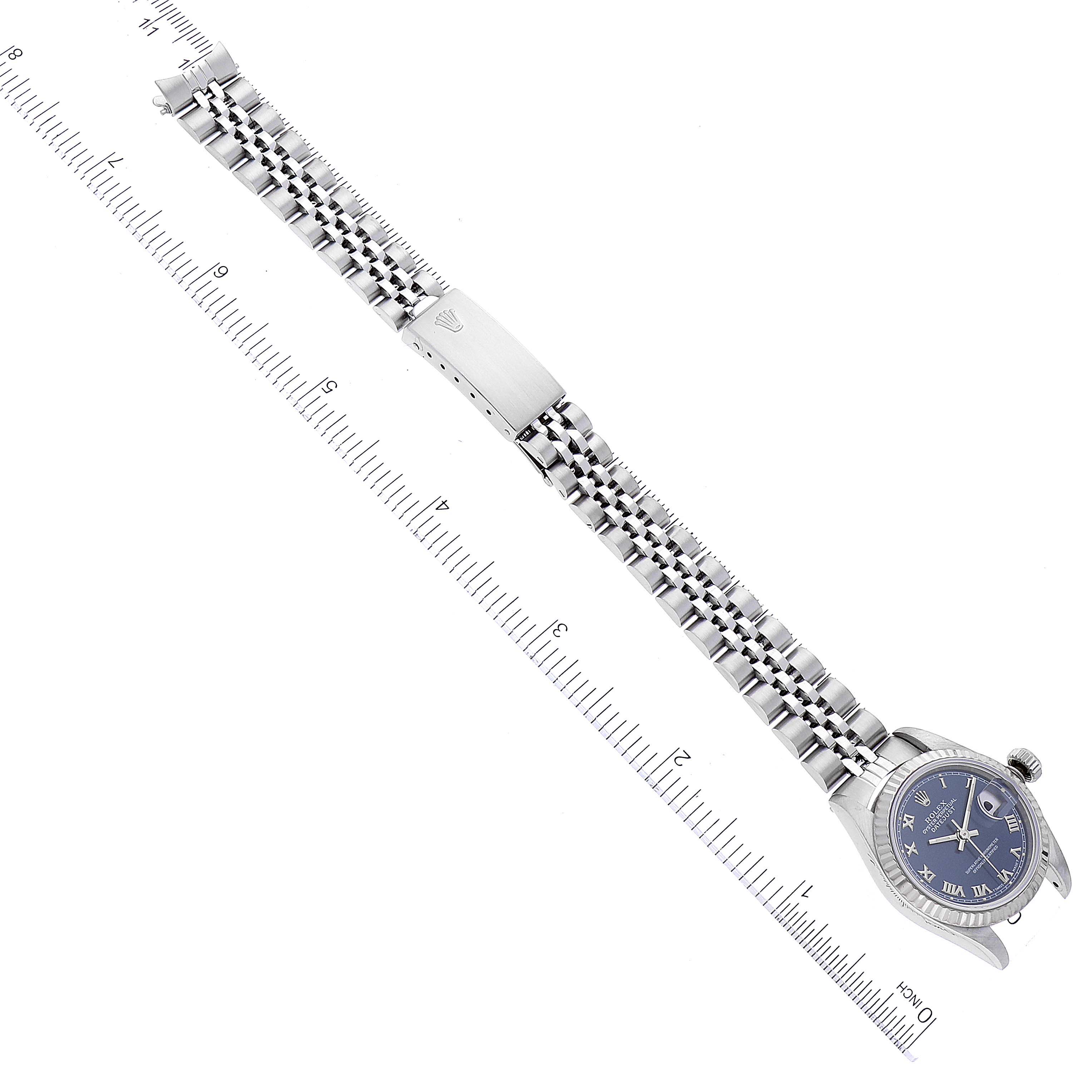 The image shows a Rolex Datejust 69174 Women's Stainless Steel Blue Dial 69174 Women's Stainless Steel Blue Dial watch laid flat, highlighting its face, bracelet, and clasp alongside a measuring ruler.