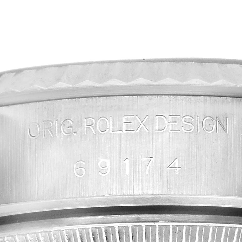 The image shows the side of a Rolex Datejust 69174 Women's Stainless Steel Pink Dial 69174 Women's Stainless Steel Pink Dial, focusing on the engraved model number and design details.