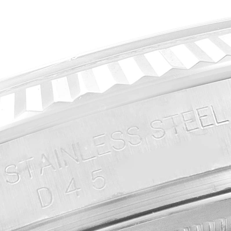 The image shows a close-up of the fluted bezel and part of the case with "STAINLESS STEEL" text on a Rolex Datejust 116234 Men
s Stainless Steel Silver Dial 116234 Men
s Stainless Steel Silver Dial watch.