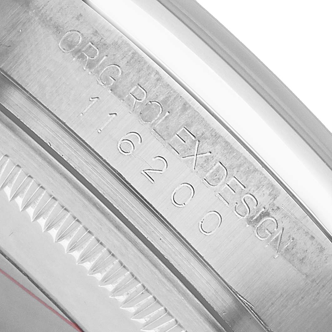 The image shows the serial engraving on the case of a Rolex Datejust 116200 Men's Stainless Steel White Dial, viewed close-up from an angled side perspective.