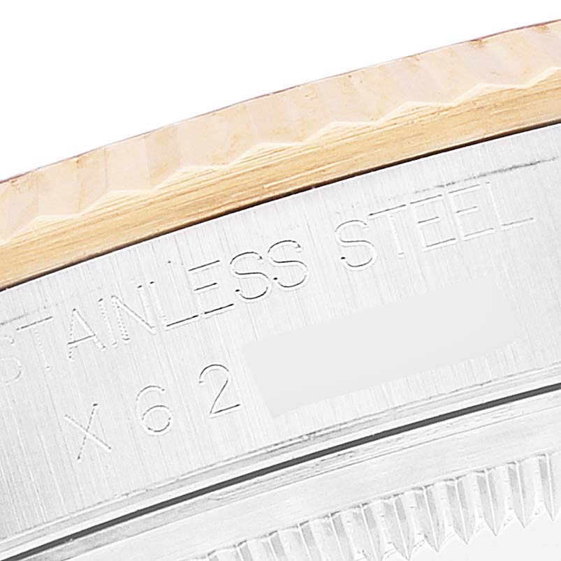 This image shows a close-up of the side view of a Rolex Datejust 16233 Men's Steel and Gold (two tone) Blue Dial 16233 Men's Steel and Gold (two tone) Blue Dial watch with the engraving "Stainless Steel."