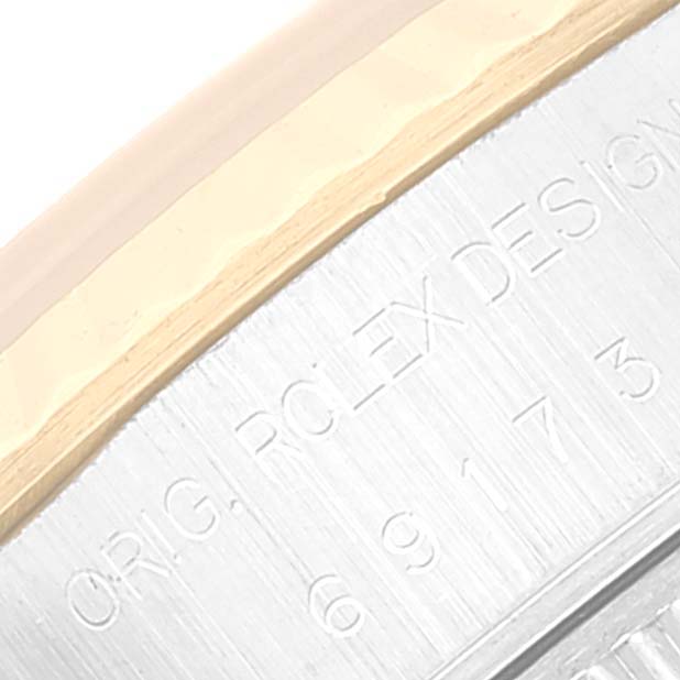 This image shows a close-up of the engraved case side of a Rolex Datejust 69173 Women's Steel and Gold (two tone) Champagne Dial 69173 Women's Steel and Gold (two tone) Champagne Dial watch.