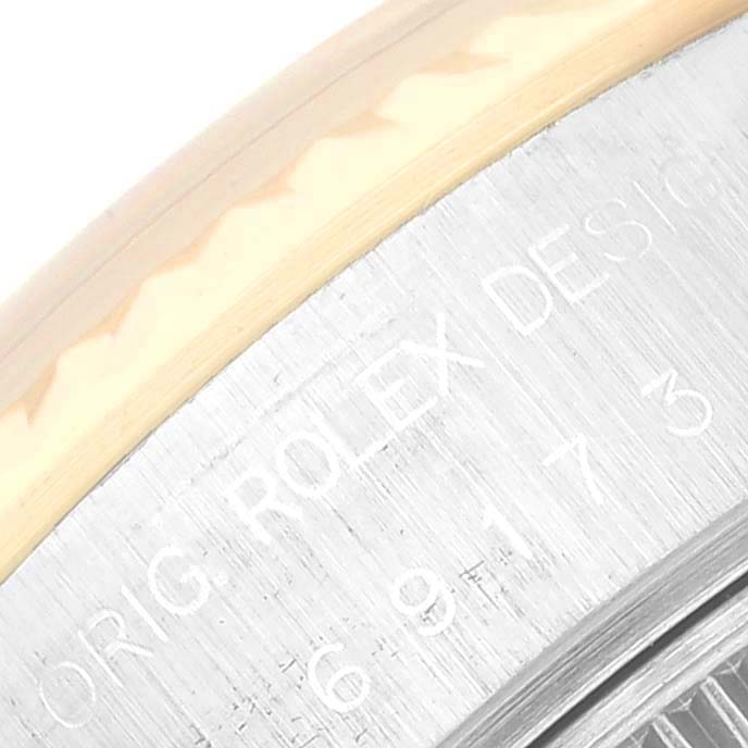 This close-up shows the engraved text on the edge of a Rolex Datejust 69173 Women's Steel and Gold (two tone) Champagne Dial 69173 Women's Steel and Gold (two tone) Champagne Dial model watch case.