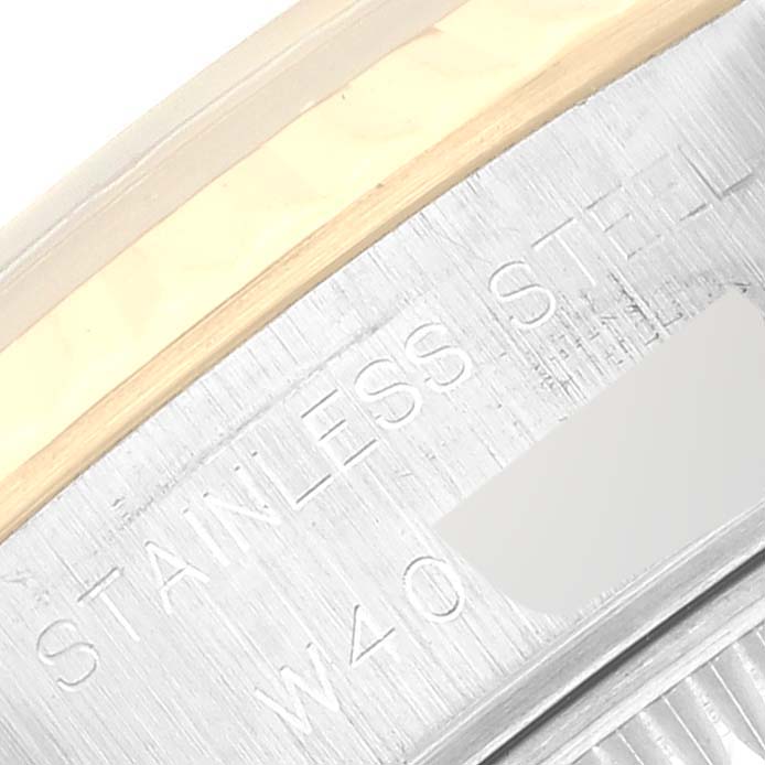 This is a close-up angle of the side of a Rolex Datejust 69173 Women's Steel and Gold (two tone) Champagne Dial 69173 Women's Steel and Gold (two tone) Champagne Dial watch, showing part of the bezel and the "STAINLESS STEEL" engraving.