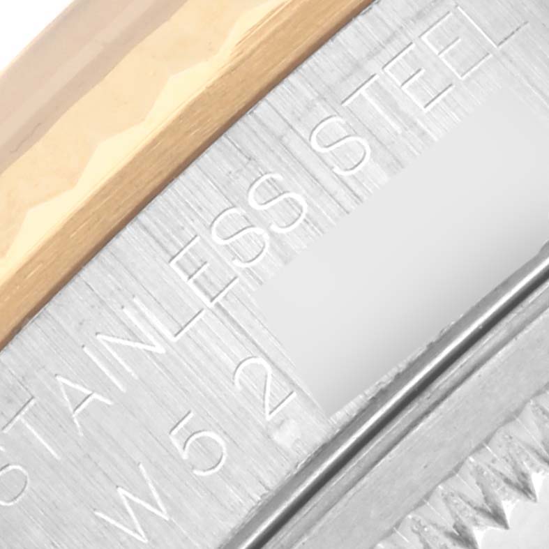 The image shows a close-up of the side engravings on the bezel and case of a Rolex Datejust 16233 Men's Steel and Gold (two tone) Beige Dial 16233 Men's Steel and Gold (two tone) Beige Dial watch.