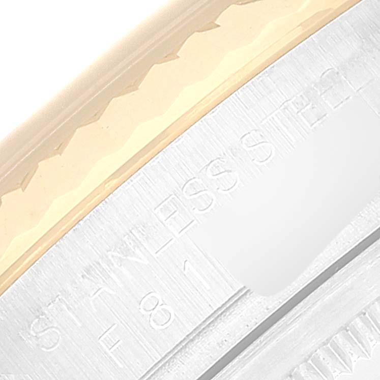 This image shows a close-up of the bezel and part of the stainless steel caseback of a Rolex Datejust 116233 Men's Steel and Gold (two tone) Mother of Pearl Dial 116233 Men's Steel and Gold (two tone) Mother of Pearl Dial watch.