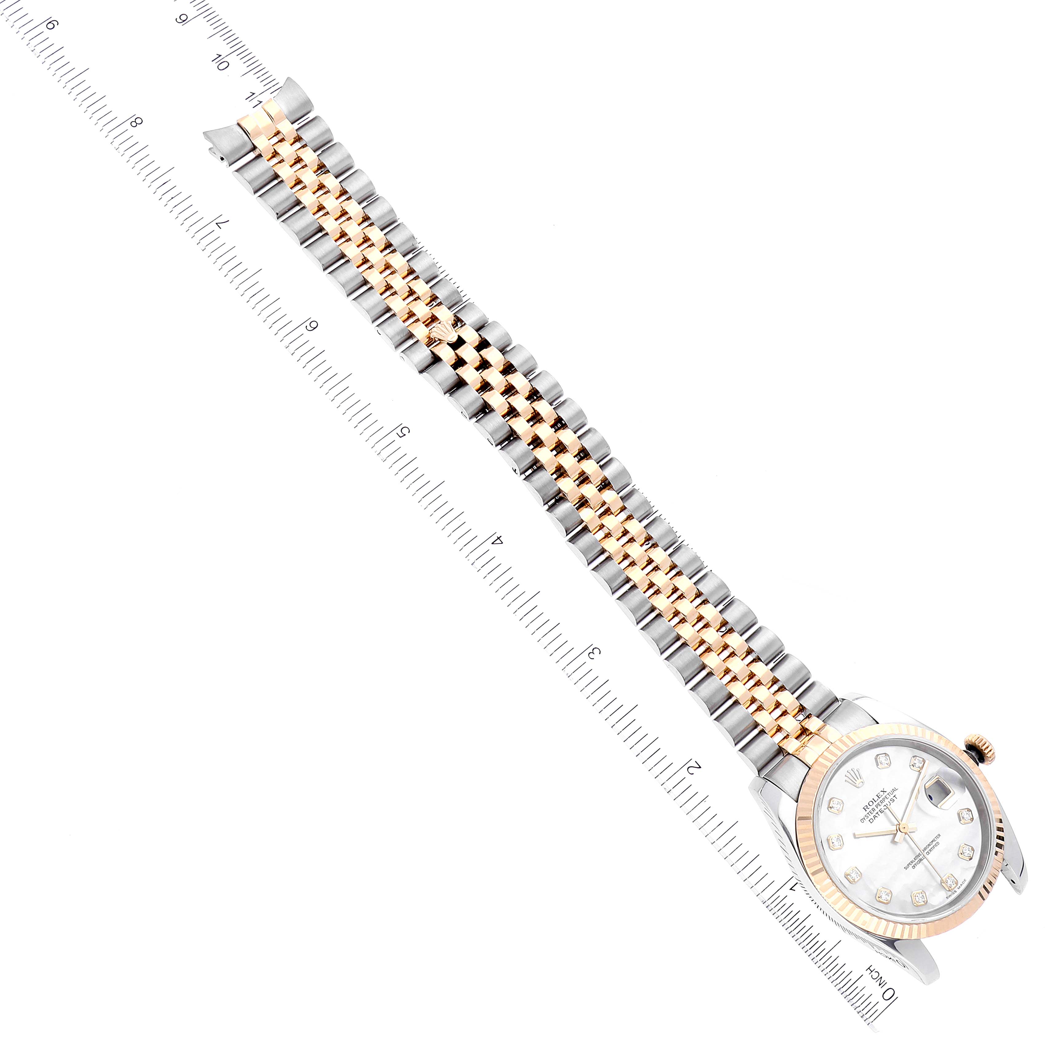 The image shows a Rolex Datejust 116233 Men's Steel and Gold (two tone) Mother of Pearl Dial 116233 Men's Steel and Gold (two tone) Mother of Pearl Dial watch laid flat, with emphasis on the bracelet and face, alongside a measuring ruler for scale.