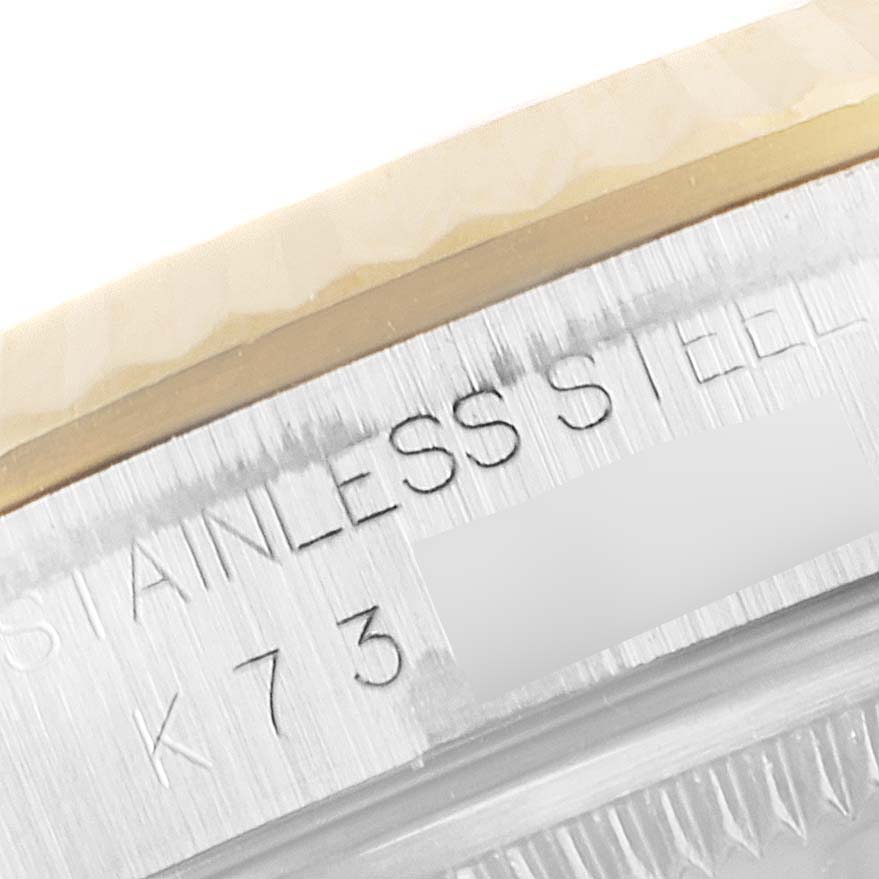 This image shows a close-up of the engraved bezel and case of a Rolex Datejust 16233 Men's Steel and Gold (two tone) White Dial 16233 Men's Steel and Gold (two tone) White Dial watch, revealing the "STAINLESS STEEL" text.