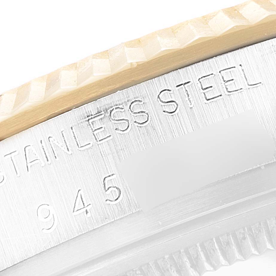 The image shows a close-up of the side of a Vintage Collection Rolex watch, highlighting the stainless steel bezel and engraved numbering.