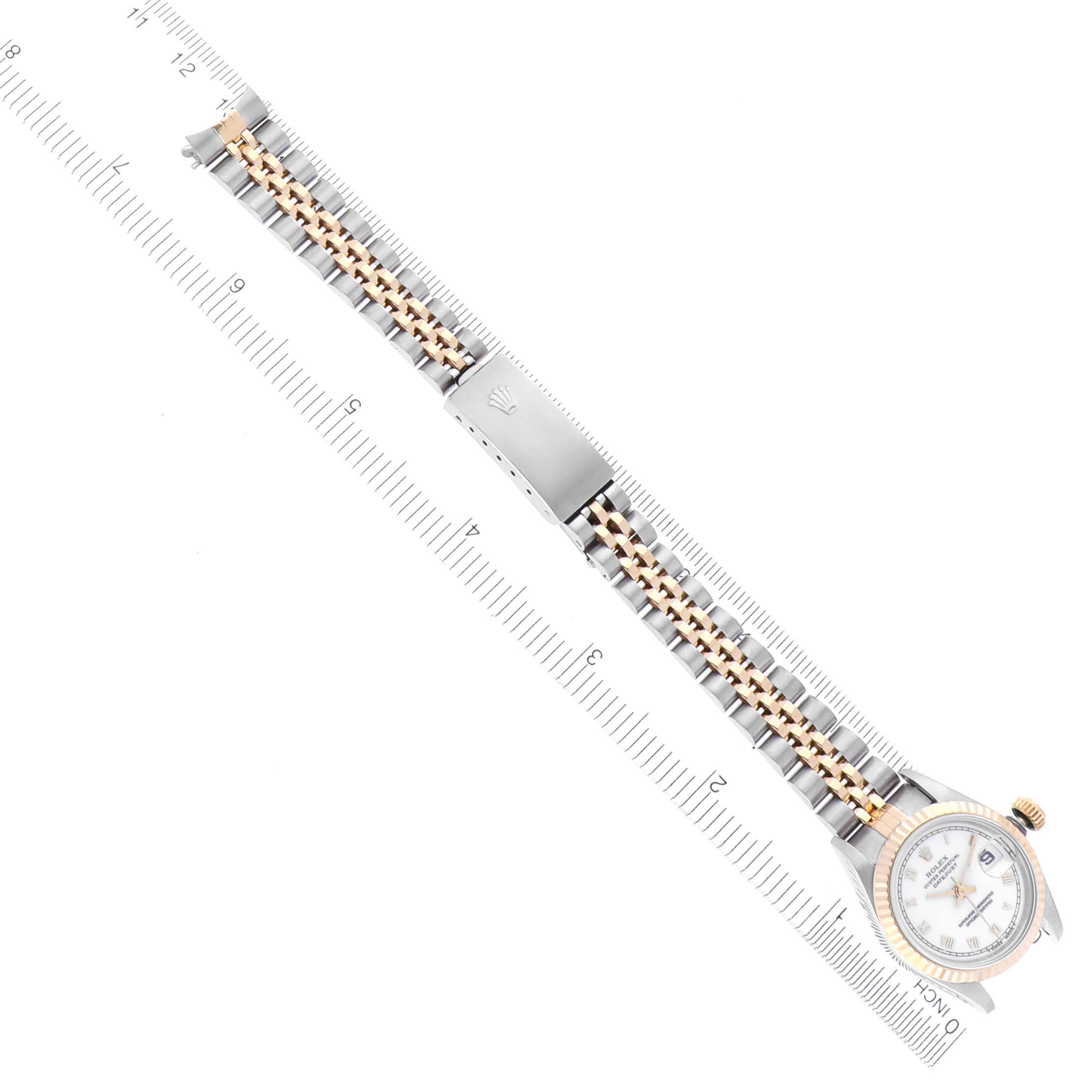 The Rolex Datejust 69173 Women's Steel and Gold (two tone) White Dial 69173 Women's Steel and Gold (two tone) White Dial watch is shown from an overhead angle, displaying the dial, bracelet, and clasp along a ruler.