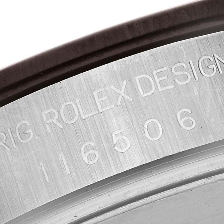 The image shows a close-up of the engraved bezel edge of a Rolex Daytona 116506 Men's Platinum Blue Dial 116506 Men's Platinum Blue Dial, focusing on the model's serial and design numbers.