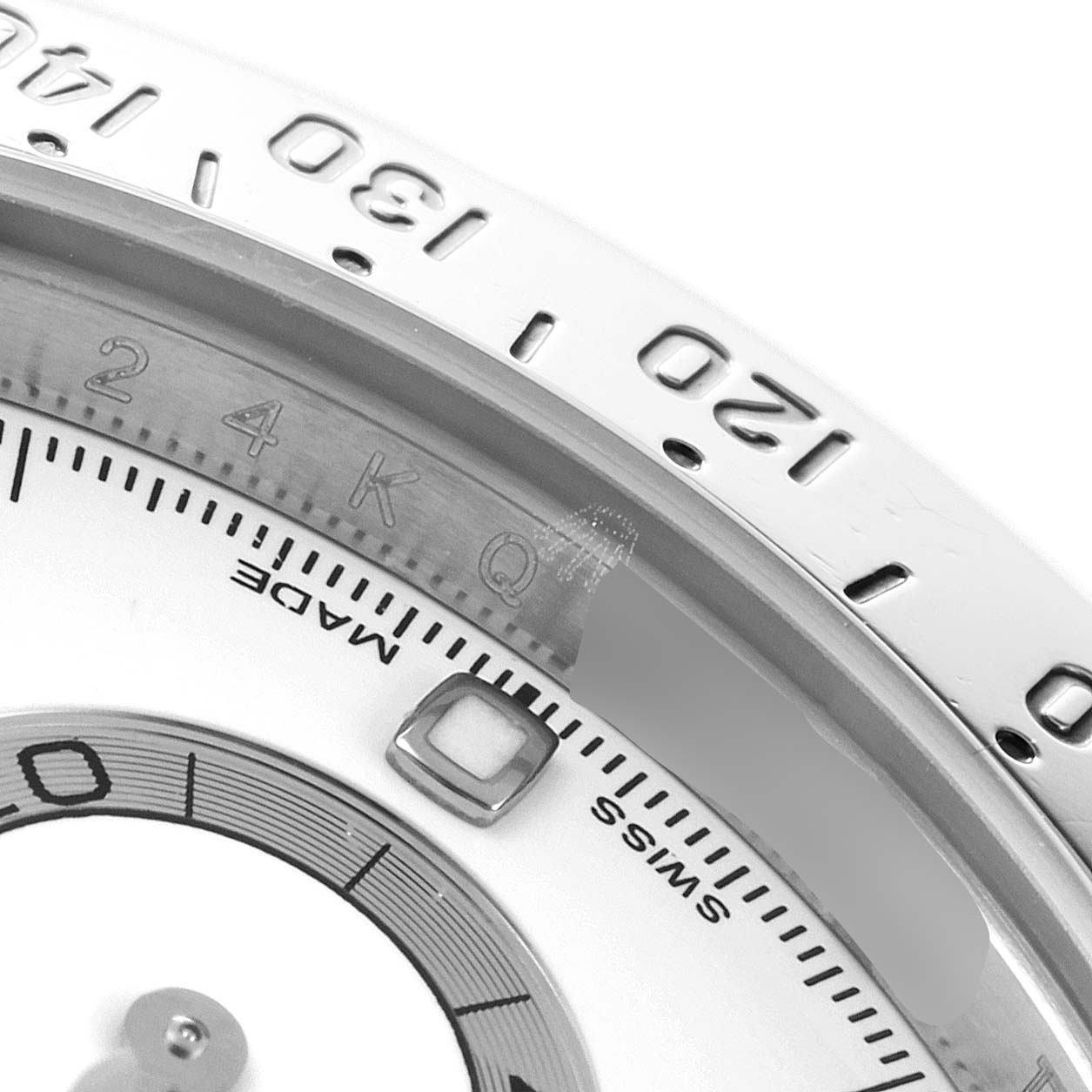 The image shows a close-up view of the tachymeter and part of the dial of a Rolex Daytona 116520 Men's Stainless Steel White Dial 116520 Men's Stainless Steel White Dial watch.