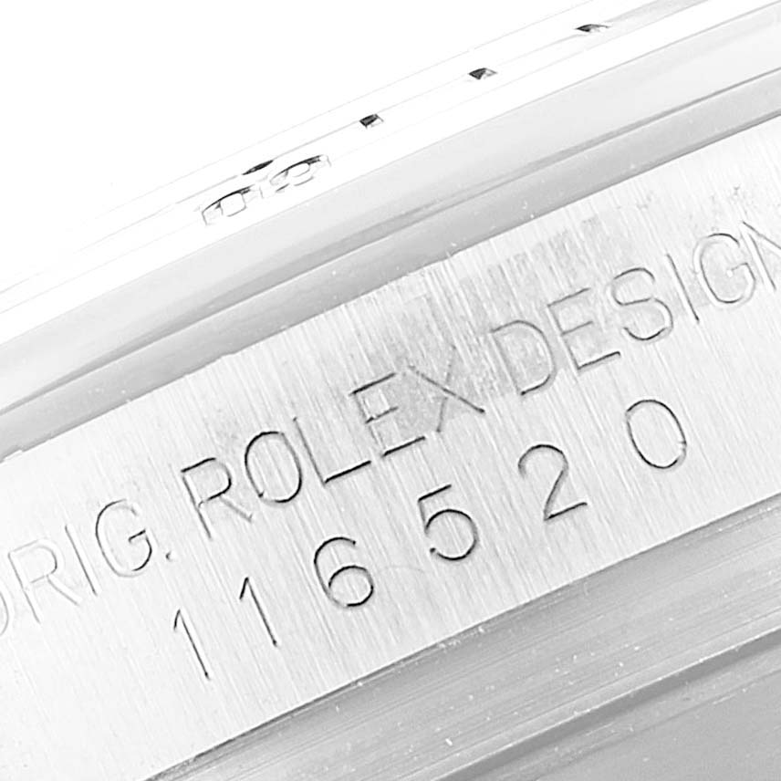 This image shows a close-up of the engraved serial number on the side of the Rolex Daytona 116520 Men's Stainless Steel White Dial 116520 Men's Stainless Steel White Dial watch case.