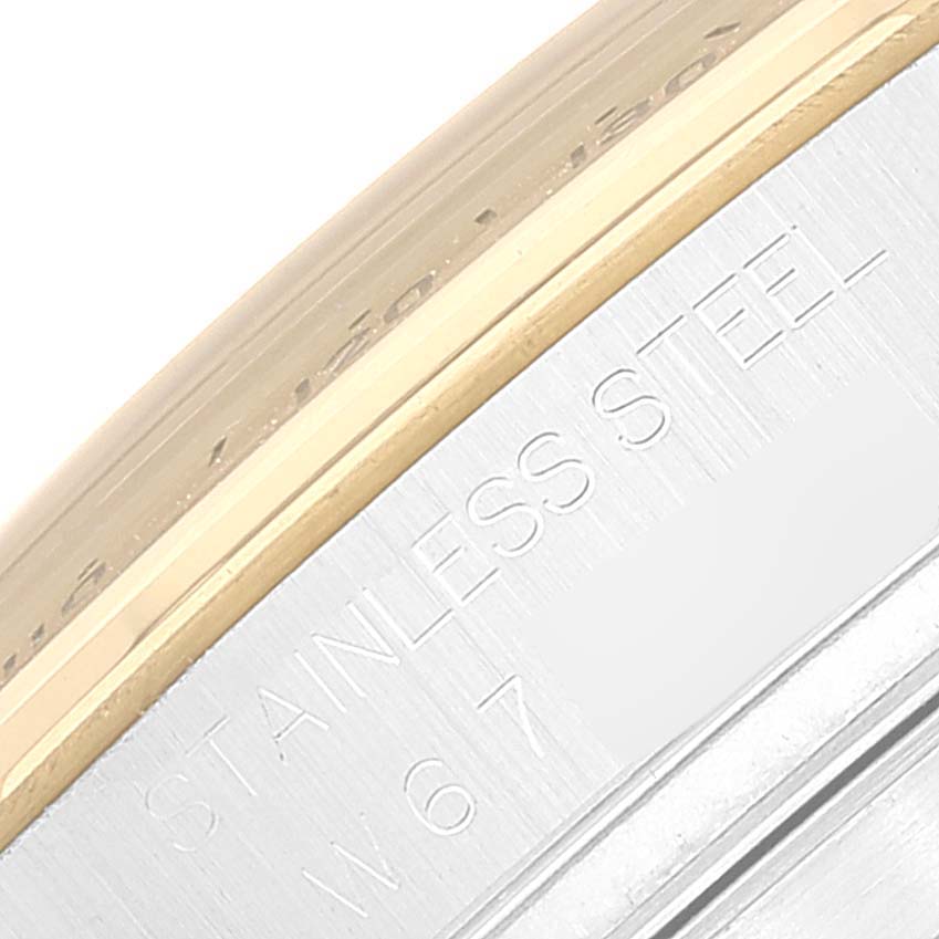The image shows a close-up of the edge, showcasing the "Stainless Steel" engraving on a Rolex Daytona 16523 Men
s Steel and Gold (two tone) White Dial 16523 Men
s Steel and Gold (two tone) White Dial model watch.