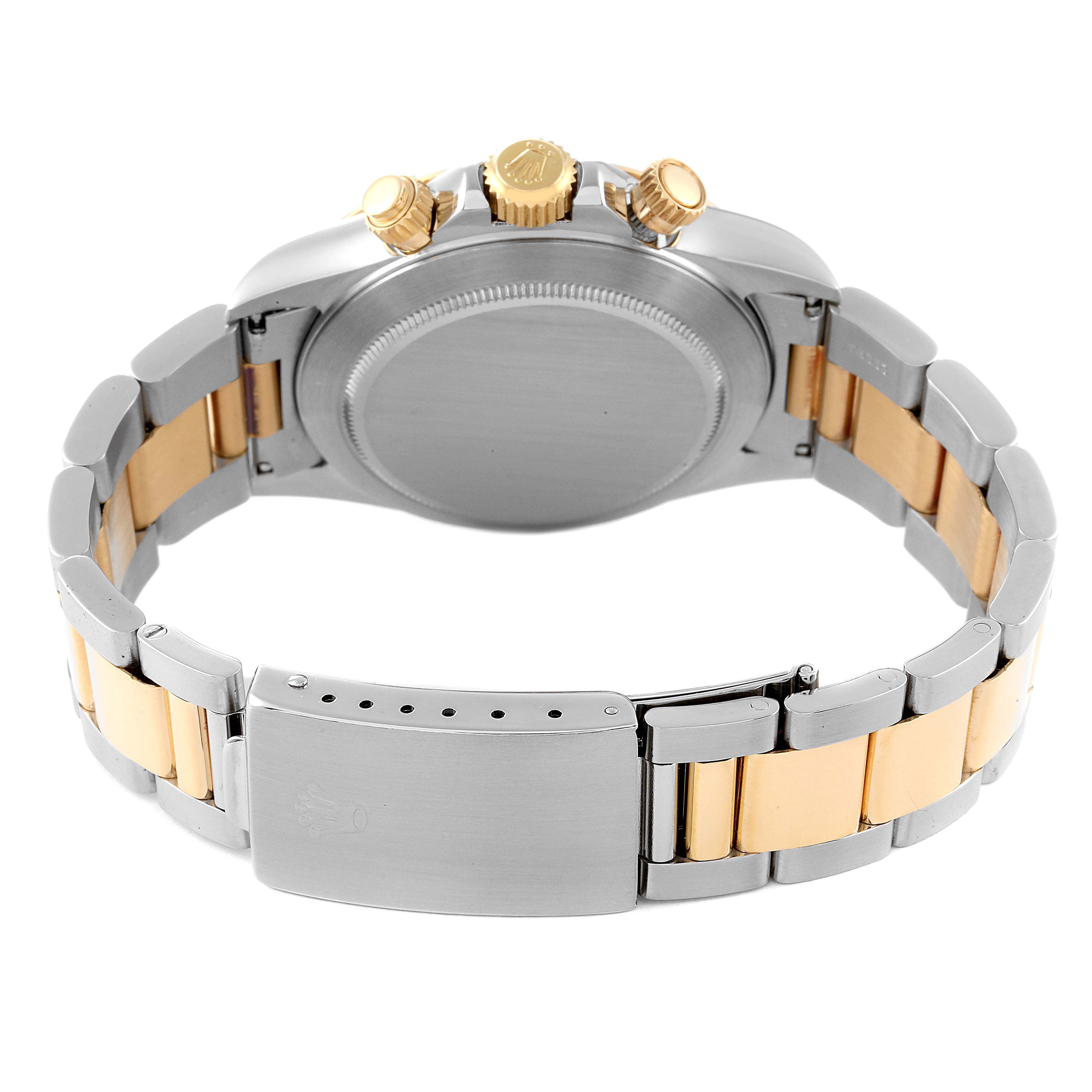 The image shows a back view of a Rolex Daytona 16523 Men
s Steel and Gold (two tone) White Dial 16523 Men
s Steel and Gold (two tone) White Dial watch, highlighting its clasp, bracelet, and crown.