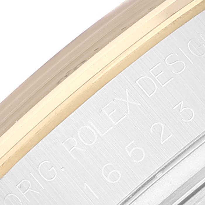 This image shows a close-up of the engraved side of the bezel on a Rolex Daytona 16523 Men
s Steel and Gold (two tone) White Dial 16523 Men
s Steel and Gold (two tone) White Dial watch.