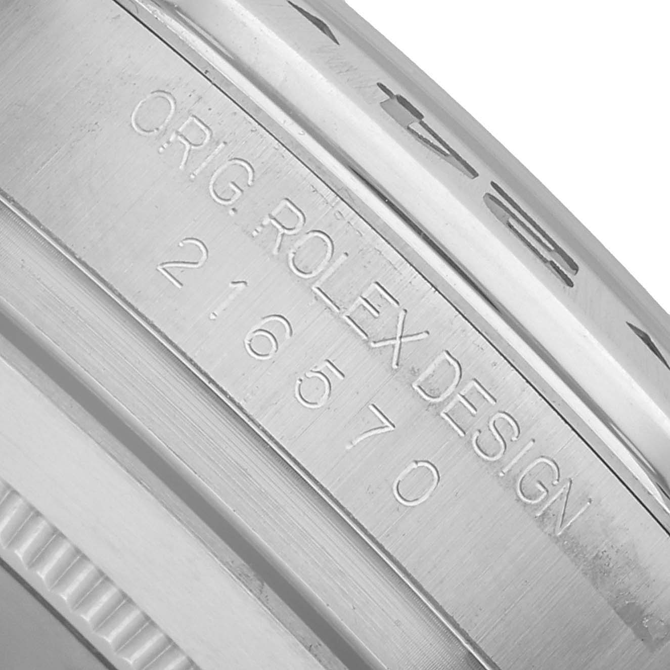 The image shows a close-up of the Rolex Explorer 216570 Men's Stainless Steel White Dial's case side, displaying the "ORIG. ROLEX DESIGN" engraving and model number 216570.