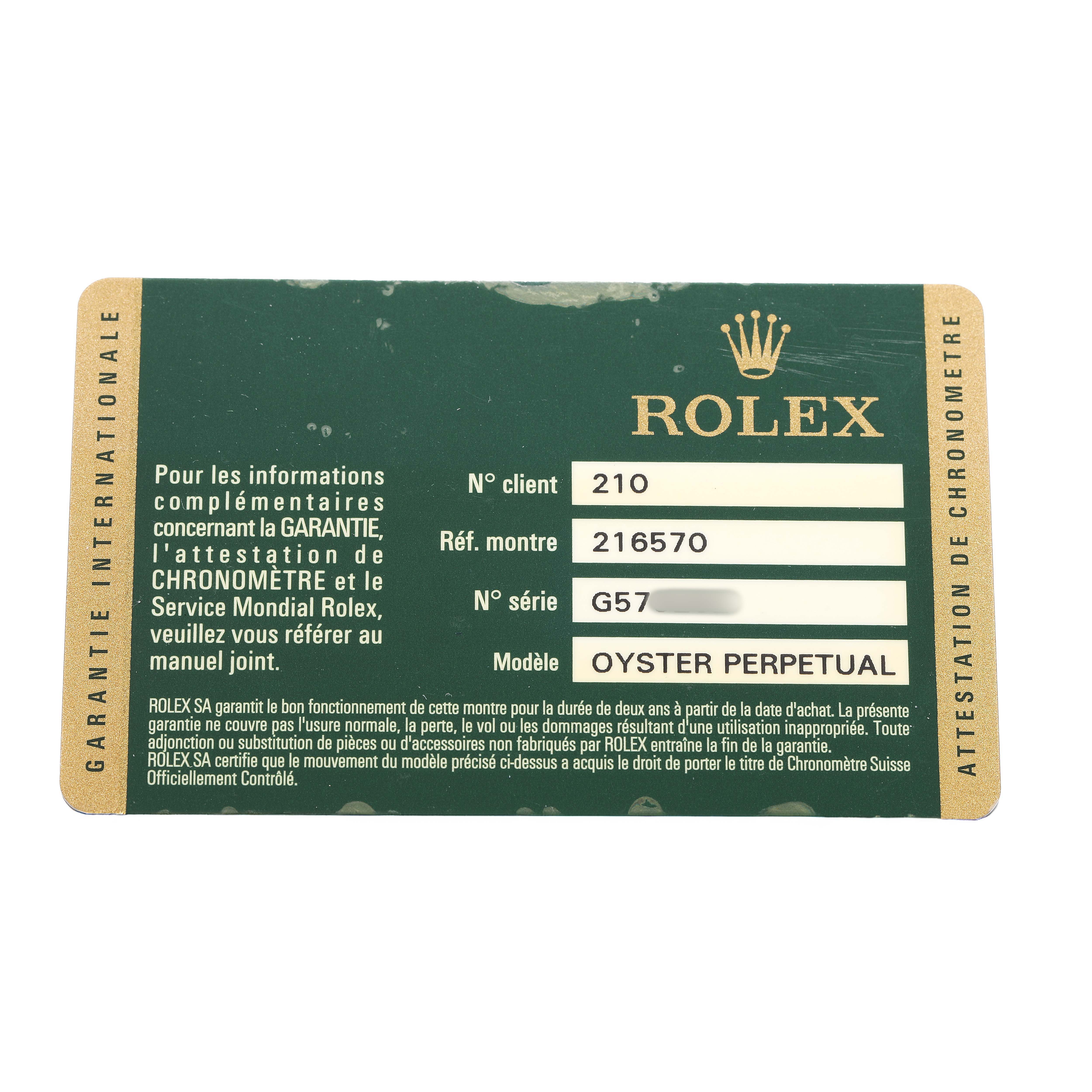 The image shows a Rolex Explorer 216570 Men's Stainless Steel White Dial model warranty card, featuring details like model and serial numbers.