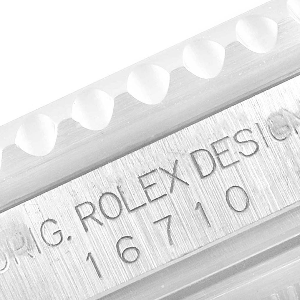 The image shows a close-up of the engraved model number and design inscription on the case of a Rolex GMT-Master 16710 Men
s Stainless Steel Black Dial 16710 Men
s Stainless Steel Black Dial watch.