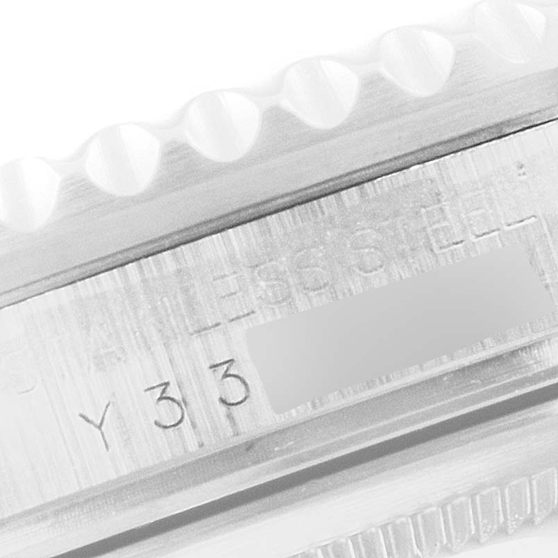 The image shows a close-up angle of the side of the Rolex GMT-Master 16710 Men
s Stainless Steel Black Dial 16710 Men
s Stainless Steel Black Dial model, displaying the serial number and part of the stainless steel bezel.