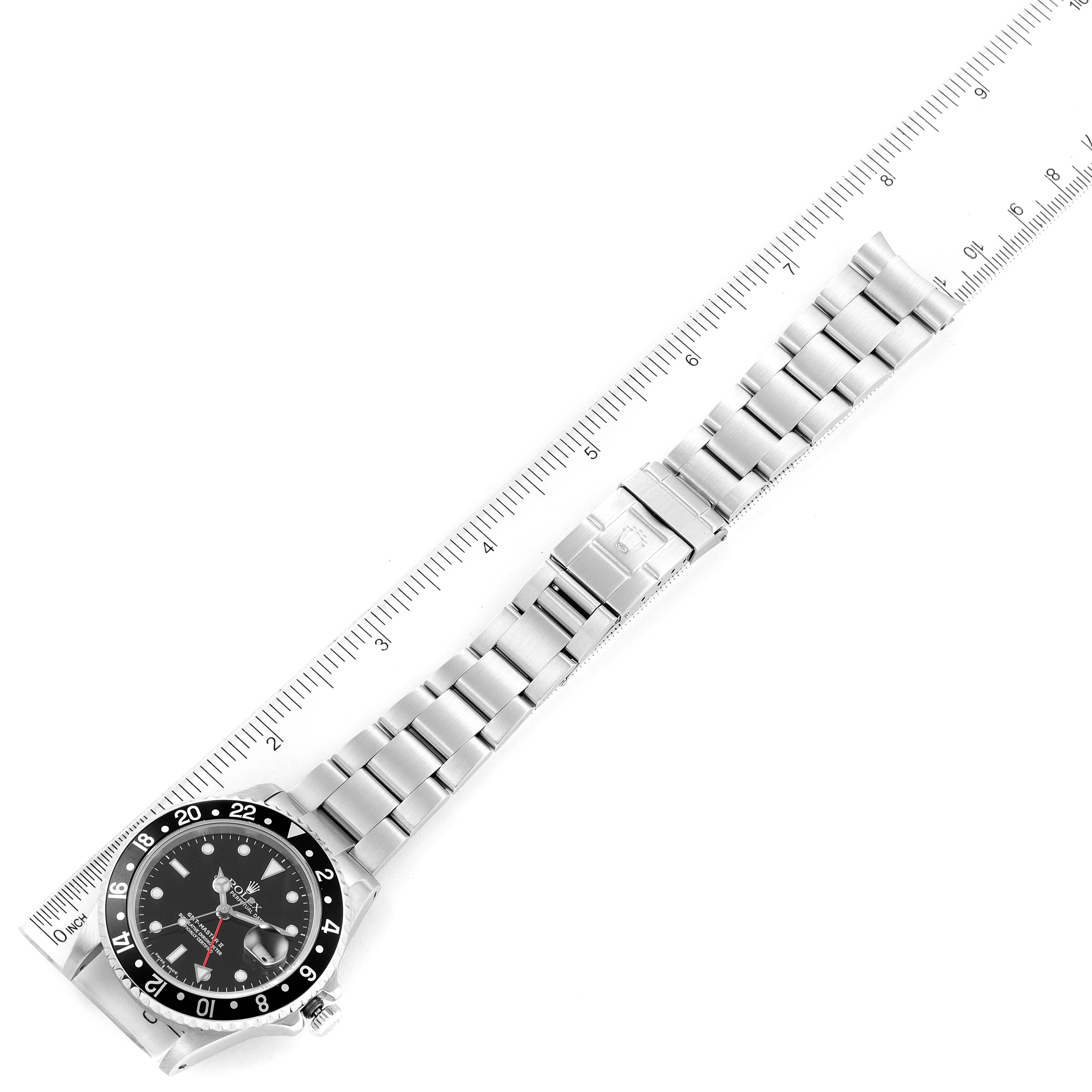 The image shows the Rolex GMT-Master 16710 Men
s Stainless Steel Black Dial 16710 Men
s Stainless Steel Black Dial watch laid flat with a ruler for scale.