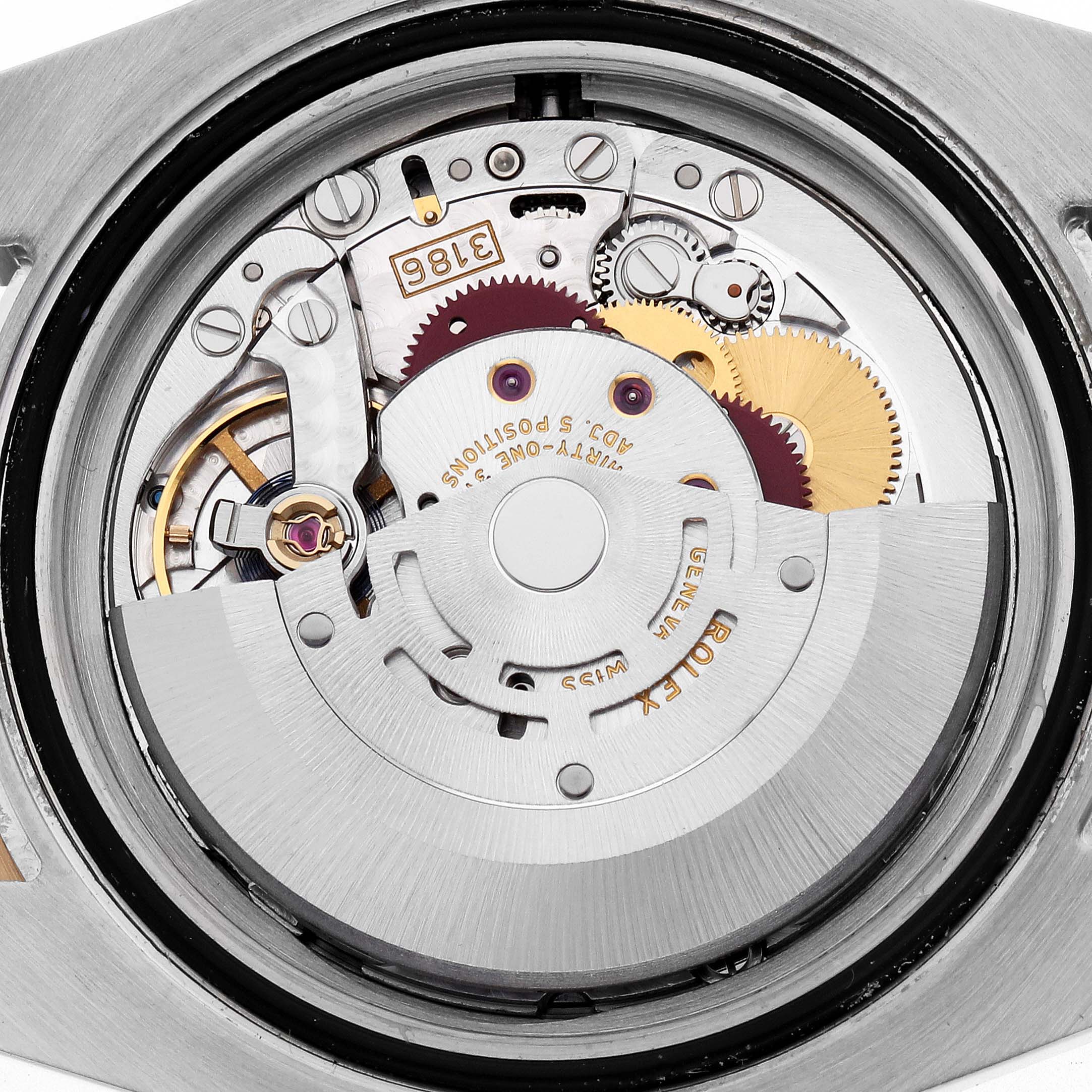 The image shows the Rolex GMT-Master 116713 Men's Steel and Gold (two tone) Black Dial's movement from a top view, highlighting gears and intricate mechanical parts.