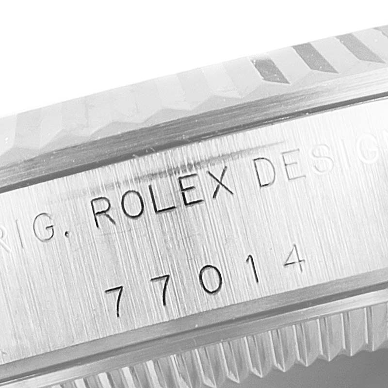 The image shows a close-up of Rolex Mid-Size 77014 Women
s Stainless Steel Silver Dial 77014 Women
s Stainless Steel Silver Dial model
s engraved watch case with the serial number "77014".