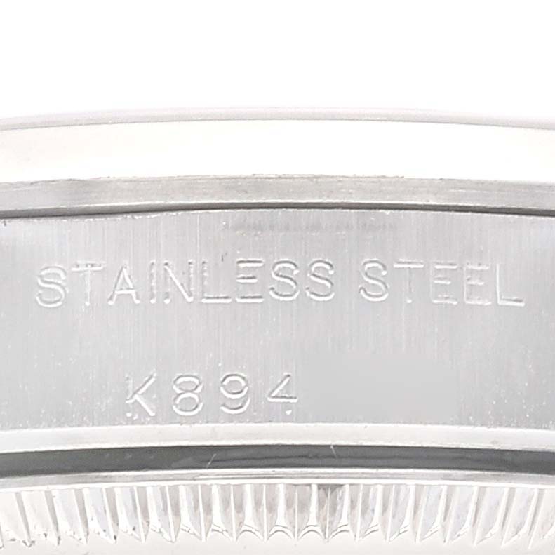 This is a close-up image showing the stainless steel case back of the Rolex Oyster Perpetual 76080 Women's Stainless Steel Black Dial 76080 Women's Stainless Steel Black Dial watch.