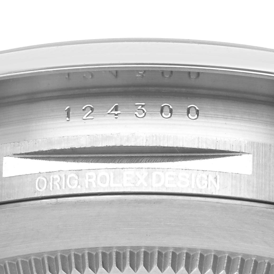 The image shows a close-up of the bezel and case back of a Rolex Oyster Perpetual 124300 Men's Stainless Steel Blue Dial 124300 Men's Stainless Steel Blue Dial, displaying the model number.