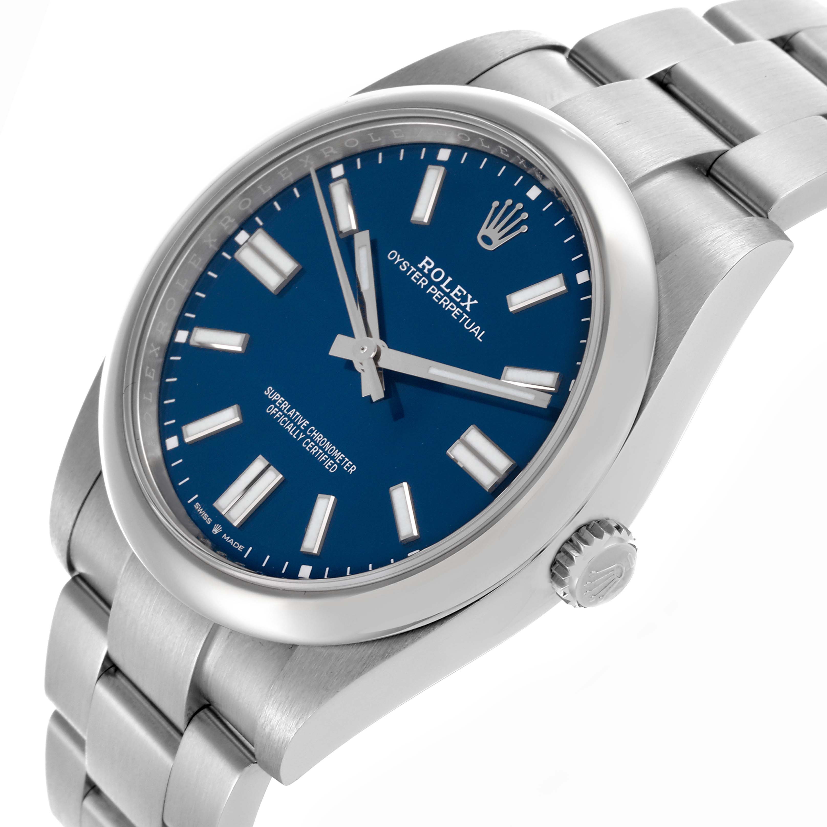 The Rolex Oyster Perpetual 124300 Men's Stainless Steel Blue Dial 124300 Men's Stainless Steel Blue Dial watch is shown from a slight side angle, highlighting the blue dial, case, crown, and bracelet.