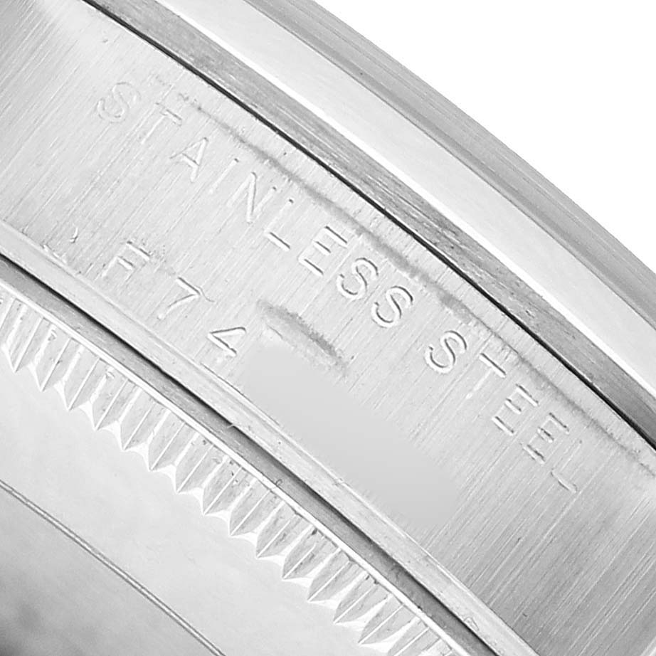 The image shows a close-up of the stainless steel band and bezel edge of a Rolex Mid-Size 77080 Women's Stainless Steel Silver Dial watch.