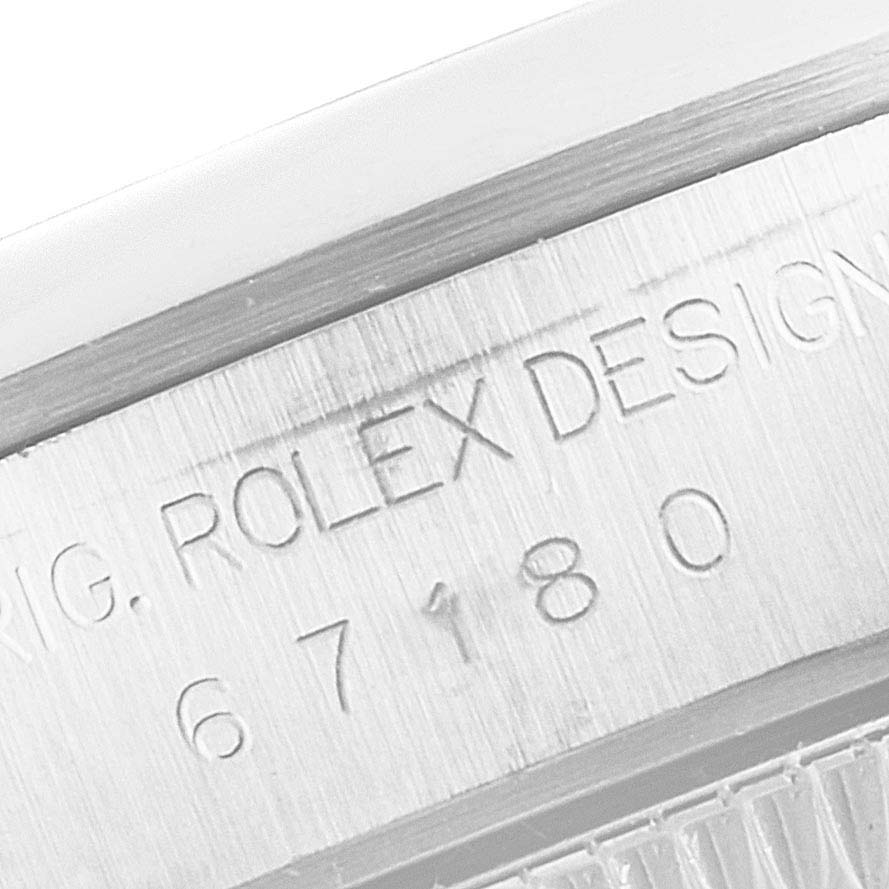 The image shows a close-up of the engraved model number and "ROLEX DESIGN" on the side of the Rolex Oyster Perpetual 67180 Women's Stainless Steel Pink Dial 67180 Women's Stainless Steel Pink Dial watch case.