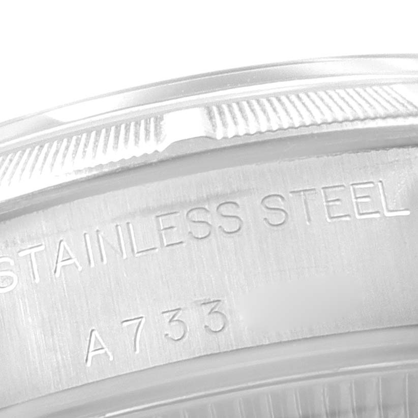 This image shows a close-up of the engraved stainless steel case back of a Rolex Oyster Perpetual 76030 Women
s Stainless Steel Blue Dial 76030 Women
s Stainless Steel Blue Dial watch.