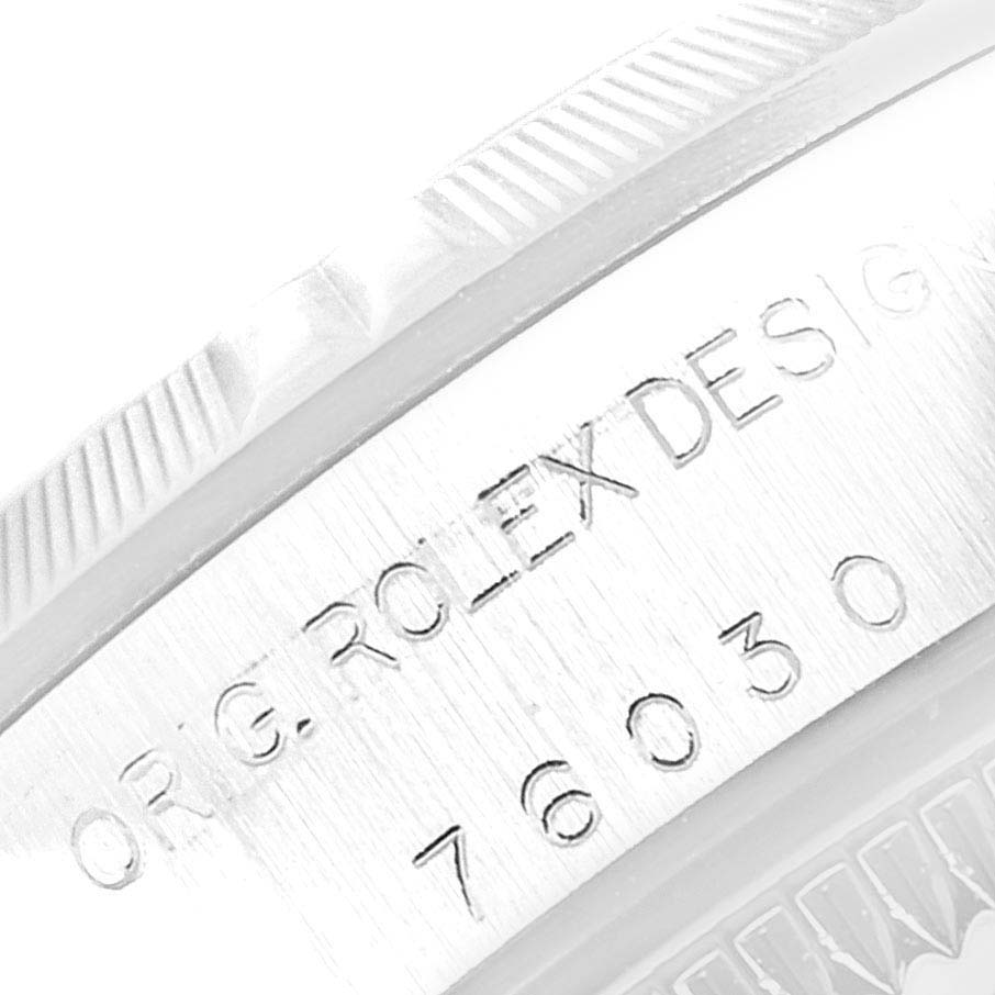 The image shows a close-up of the side of a Rolex Oyster Perpetual 76030 Women
s Stainless Steel Blue Dial 76030 Women
s Stainless Steel Blue Dial watch, highlighting the engraved model number and the brand name.