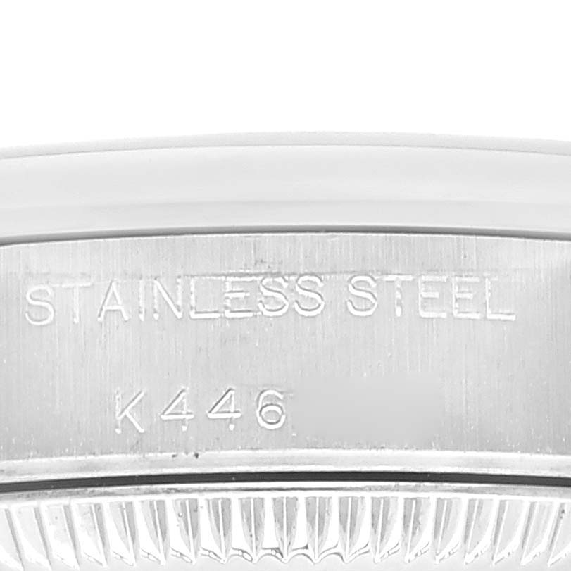 This image shows the side engraving on a Rolex Oyster Perpetual 76080 Women
s Stainless Steel Pink Dial 76080 Women
s Stainless Steel Pink Dial watch, indicating "Stainless Steel" and part of the model number.