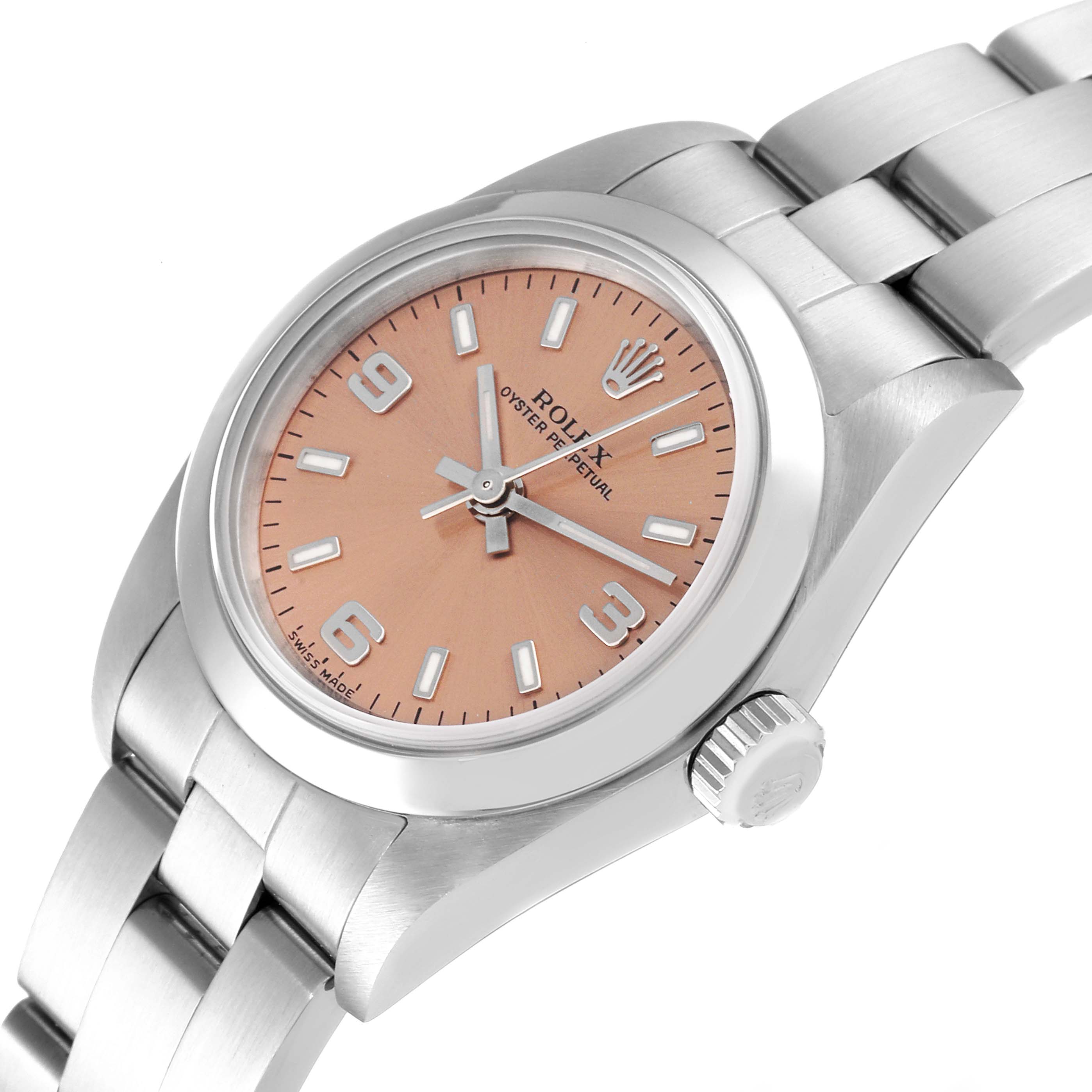 The image shows a top angled view of a Rolex Oyster Perpetual 76080 Women
s Stainless Steel Pink Dial 76080 Women
s Stainless Steel Pink Dial model, highlighting the dial, case, crown, and part of the bracelet.