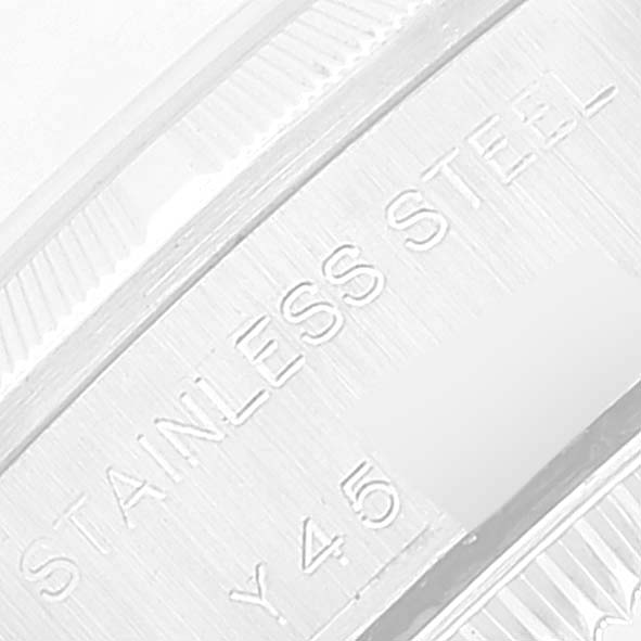 This is a close-up image showing part of the stainless steel case back of a Rolex Oyster Perpetual 76030 Women
s Stainless Steel Pink Dial 76030 Women
s Stainless Steel Pink Dial watch.