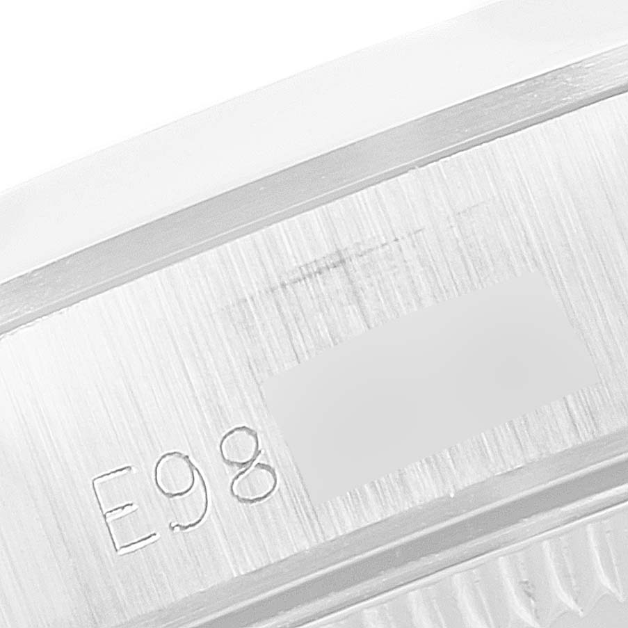 The image shows a close-up of the engraved serial number on the side of the case of a Rolex Oyster Perpetual 67180 Women's Stainless Steel Silver Dial 67180 Women's Stainless Steel Silver Dial watch.