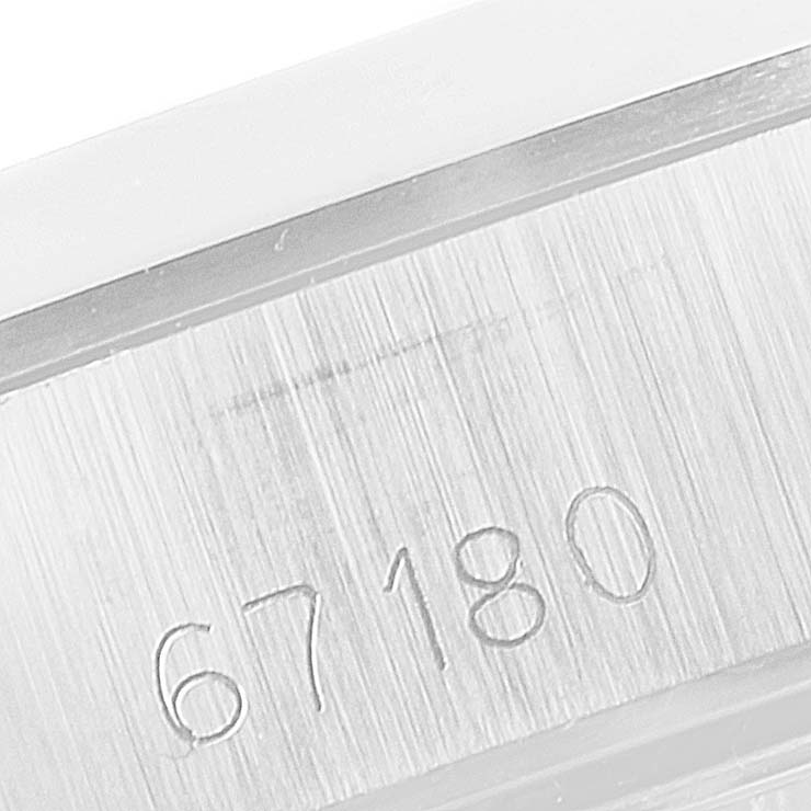 The image shows a close-up angle of the serial number engraving on the case of a Rolex Oyster Perpetual 67180 Women's Stainless Steel Silver Dial 67180 Women's Stainless Steel Silver Dial watch.