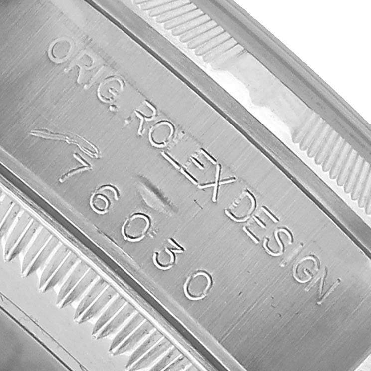 The image shows a close-up of the side engraving on a Rolex Oyster Perpetual 76030 Women's Stainless Steel Black Dial watch case.