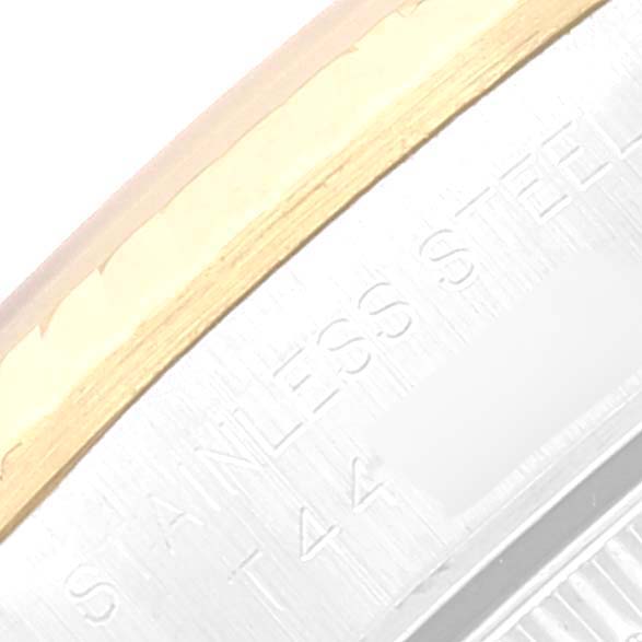 This close-up image shows part of the bezel and the stainless steel case of a Rolex Oyster Perpetual 67193 Women's Steel and Gold (two tone) Blue Dial 67193 Women's Steel and Gold (two tone) Blue Dial watch.