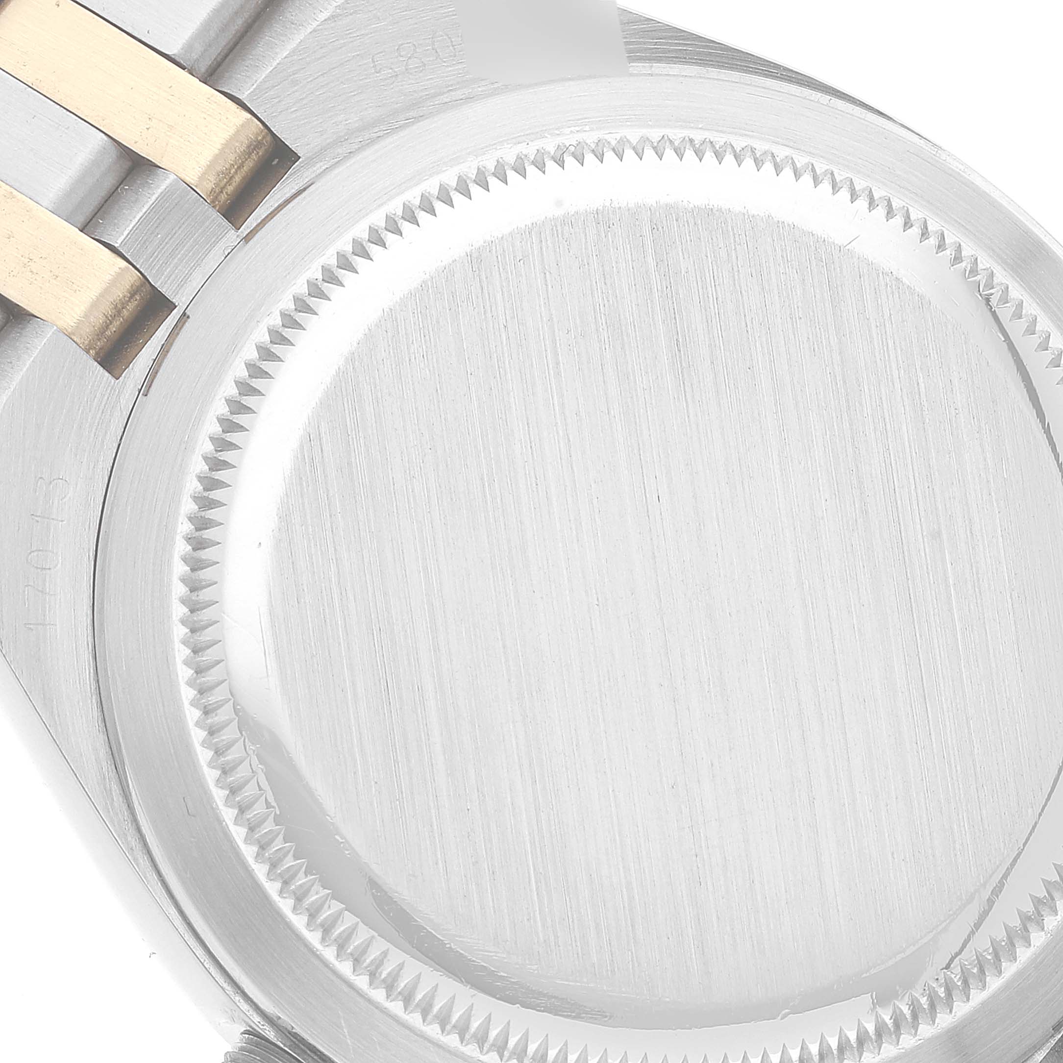 The image shows a close-up view of the case back and part of the bracelet of the Rolex Oysterquartz 17013 Men's Steel and Gold (two tone) Champagne Dial 17013 Men's Steel and Gold (two tone) Champagne Dial watch.