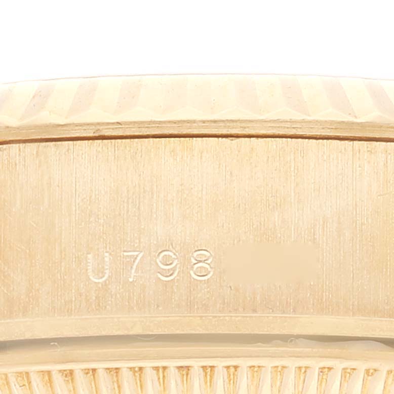 This image shows a close-up of the side of a Rolex President 79178 Women
s Yellow Gold Champagne Dial 79178 Women
s Yellow Gold Champagne Dial model, focusing on the engraved serial number.