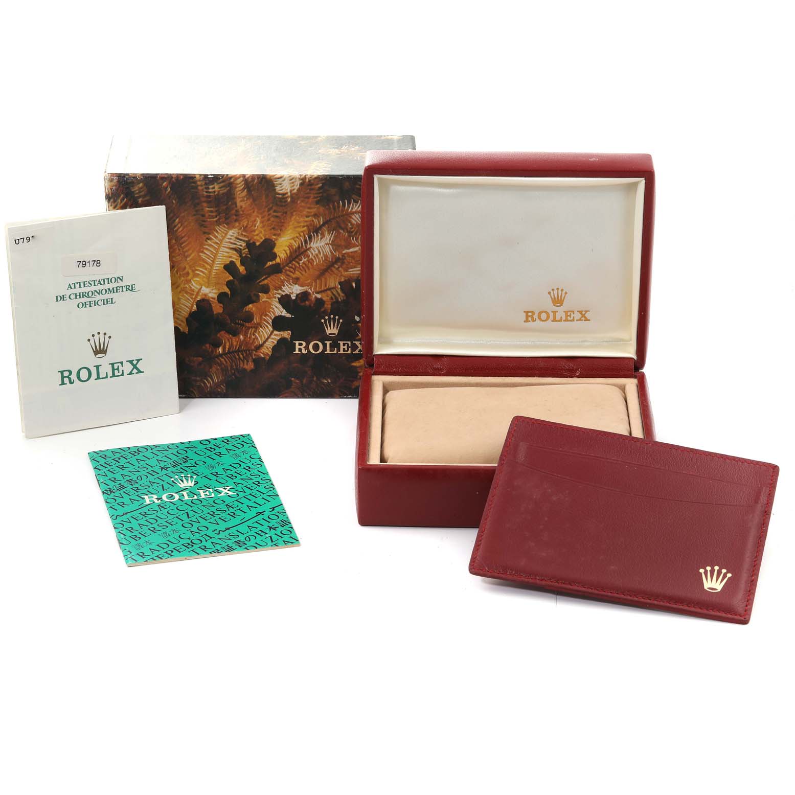 The image shows the packaging and accessories for a Rolex President 79178 Women
s Yellow Gold Champagne Dial 79178 Women
s Yellow Gold Champagne Dial model, including a box, manuals, and a card holder.