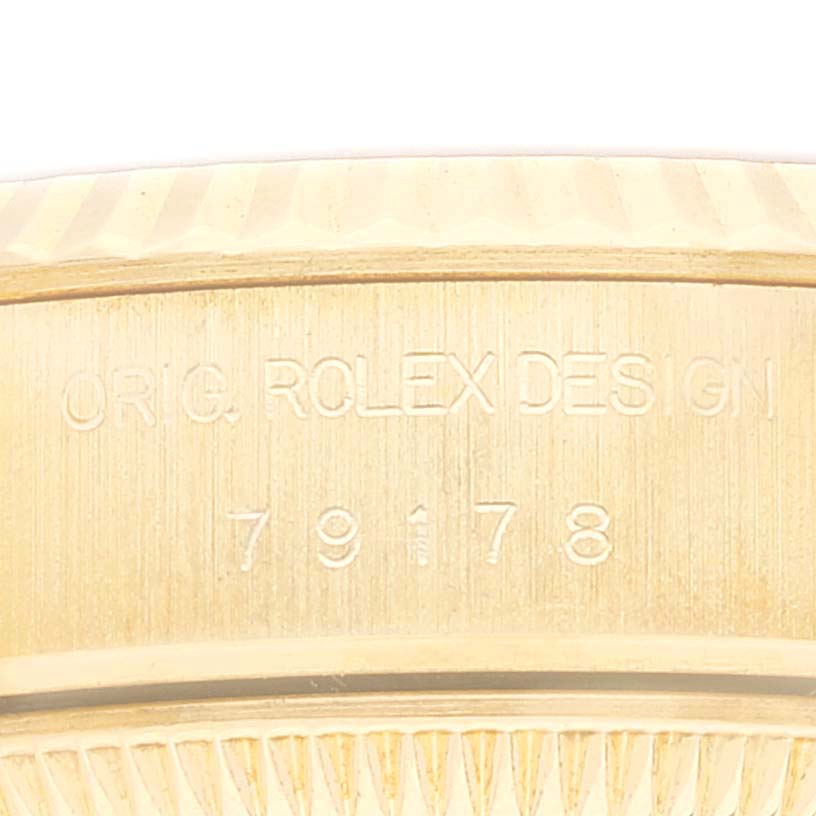 The image shows a close-up angle of the case side of a Rolex President 79178 Women
s Yellow Gold Champagne Dial 79178 Women
s Yellow Gold Champagne Dial model, featuring engraved text and model number 79178.