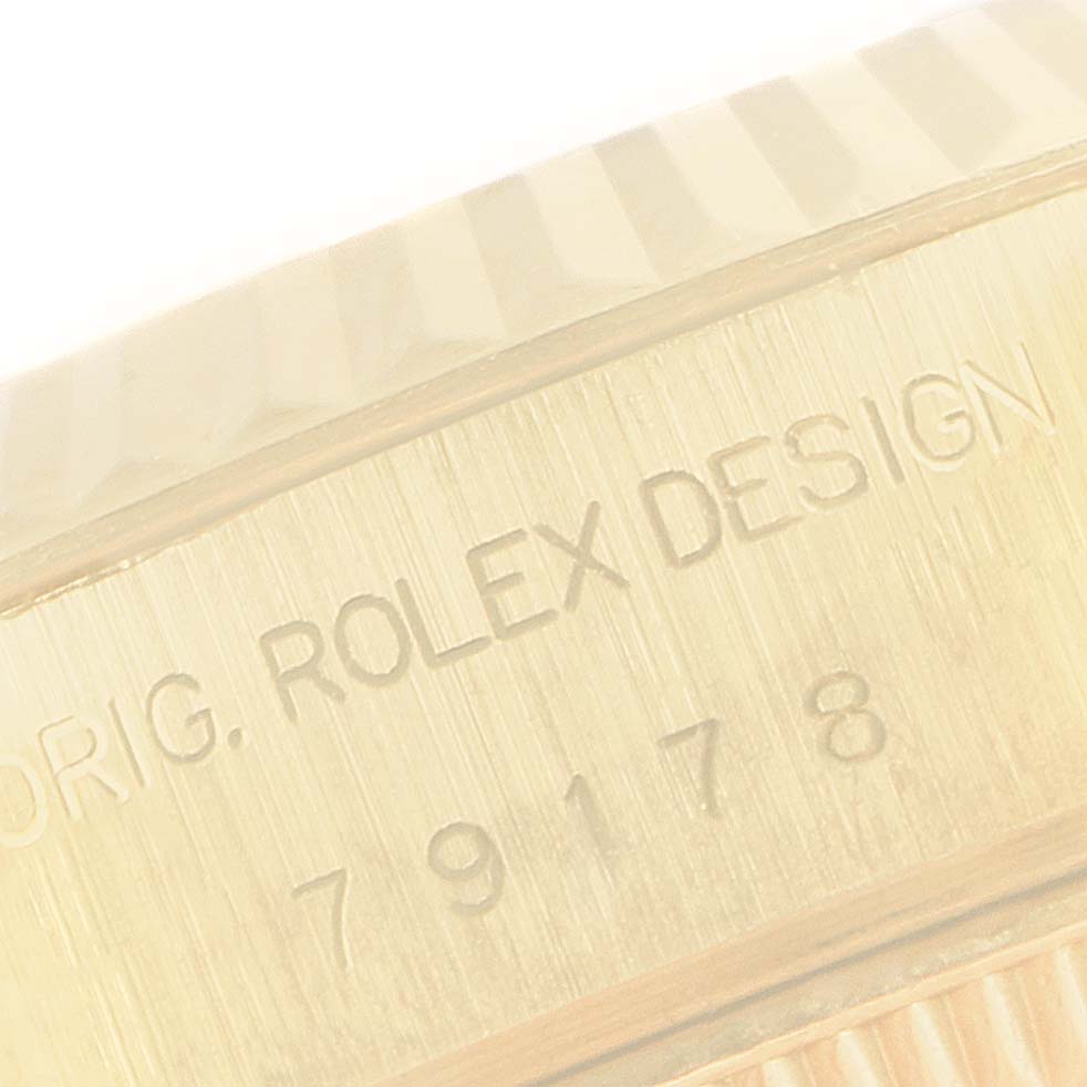 This close-up image shows the engraved bracelet clasp of a Rolex President 79178 Women
s Yellow Gold Champagne Dial 79178 Women
s Yellow Gold Champagne Dial model watch.